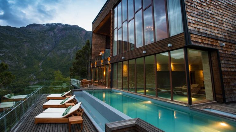 pool with loungers and hills in the background