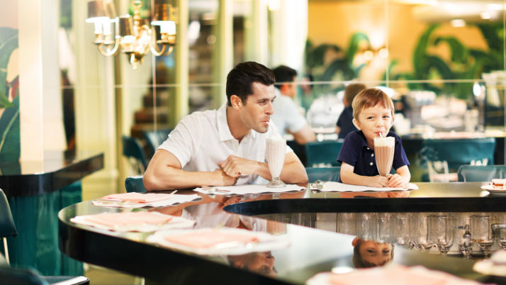 father and son with milkshakes