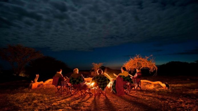 Sanctuary Kusini group around campfire