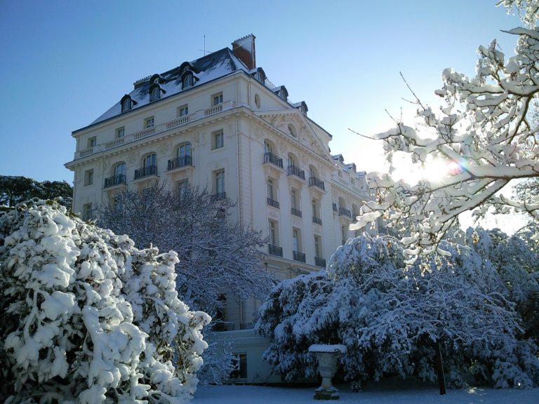 hotel in the winter surrounded by snow-covered trees