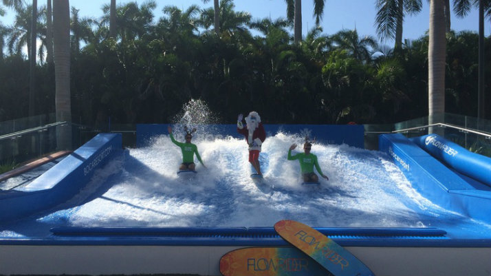 santa and surfers surfing faux waves