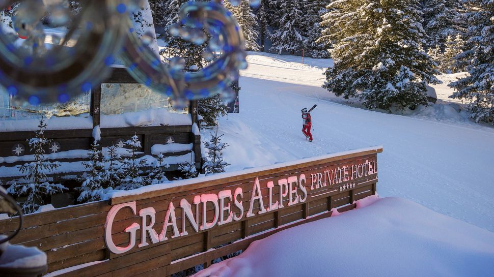 Grandes Alpes sign with skier behind