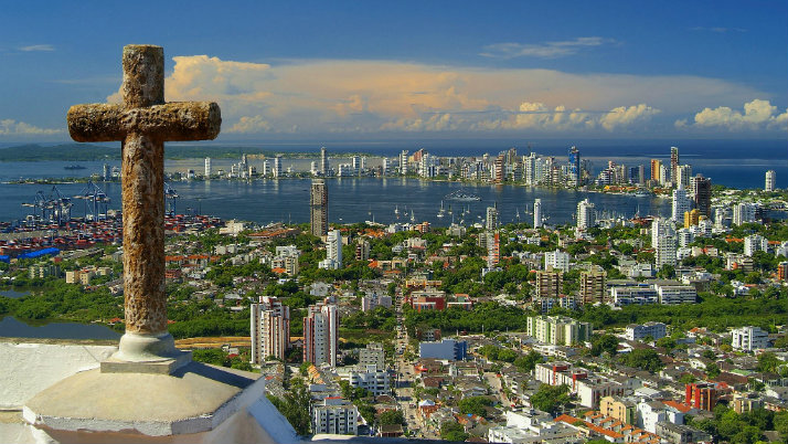 city view with church cross at forefront