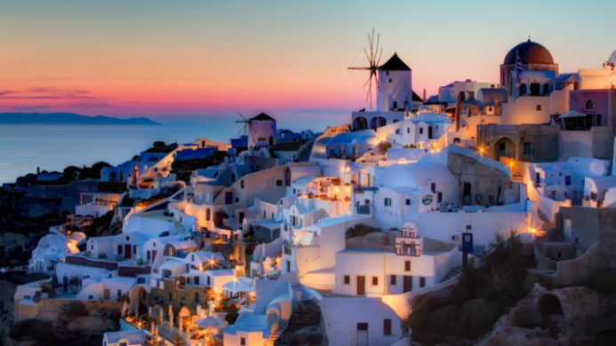 Santorini's white buildings at sunset