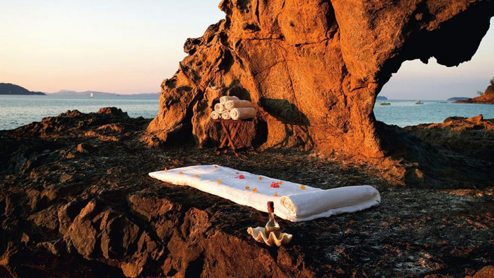 spa bed in rocks on beach
