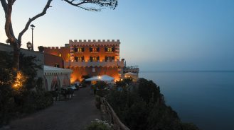 Mezzatorre Resort & Spa perched on a hill at sunset