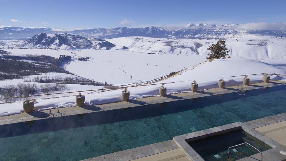 Amangani outdoor lap pool overlooking snow landscape
