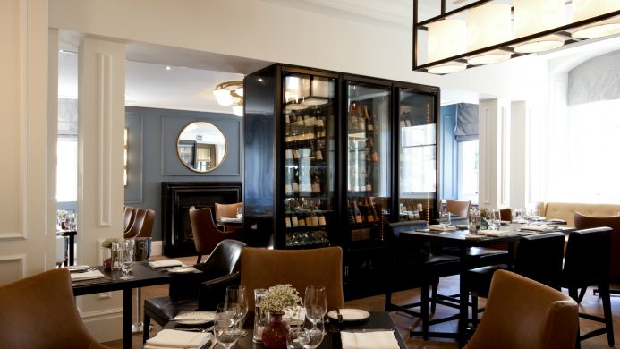 Hotel restaurant with tables and wine wall