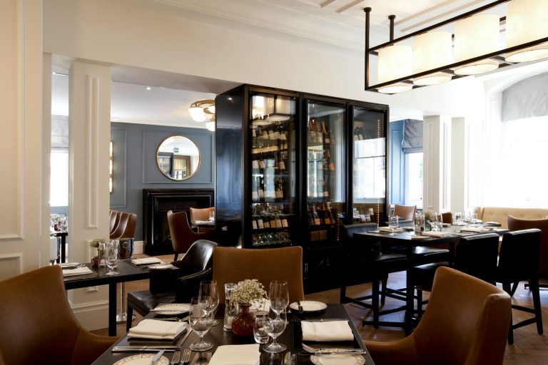 Hotel restaurant with tables and wine wall