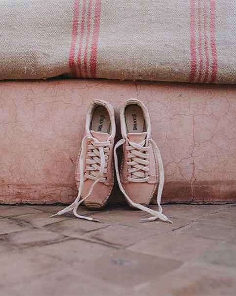 Blush pink Soludos shoes against Moroccan rugs