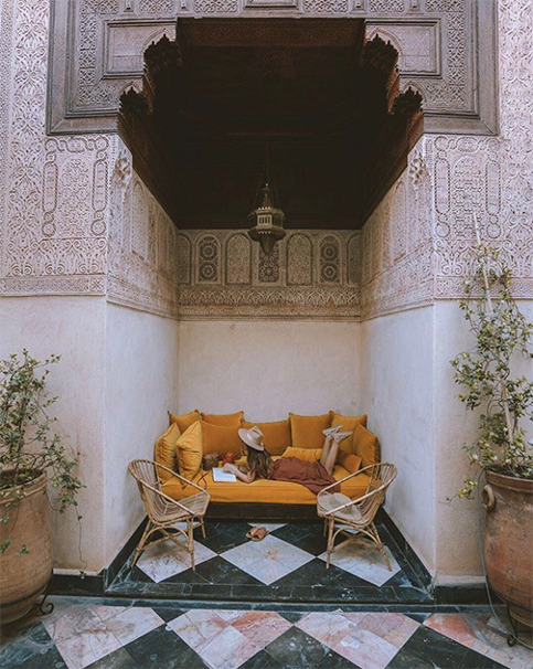 Mustard yellow couch in a cozy nook at El Fenn