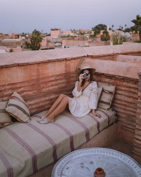 Girl with camera on rooftop