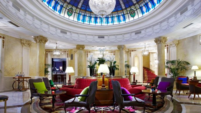 Gran Meliá Fénix hotel lobby with lounge chairs and stained glass ceiling