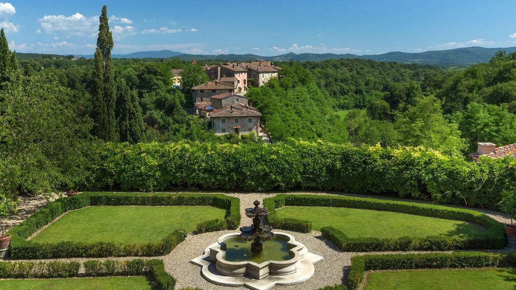 Il Borro Tuscany hotel garden surrounded by greenery and forest