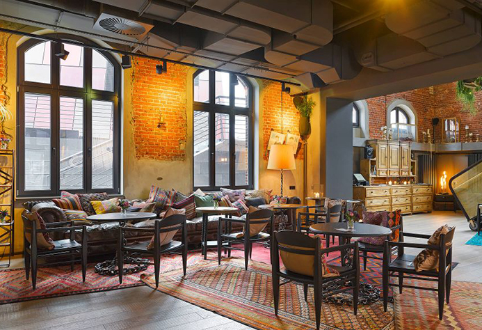 25hours Hotel Altes Hafenamt NENI Restaurant with industrial windows and exposed brick walls