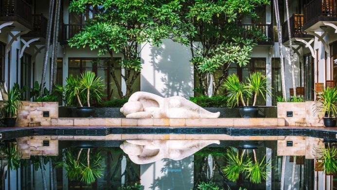 Anantara Angkor Resort pool garden with lounging statue