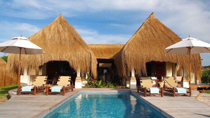 Pool in front of thatched villa at Azura resort