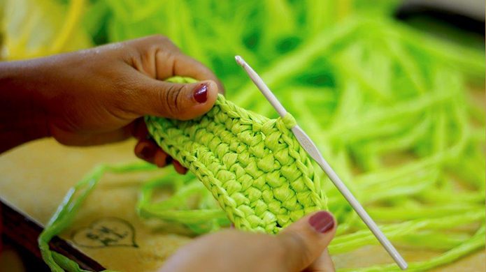 Close up of women's hands with crochet project