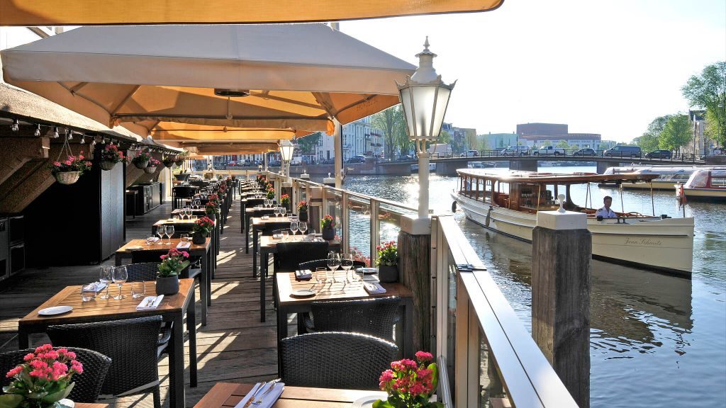 De L’Europe terrace dining over Amstel River