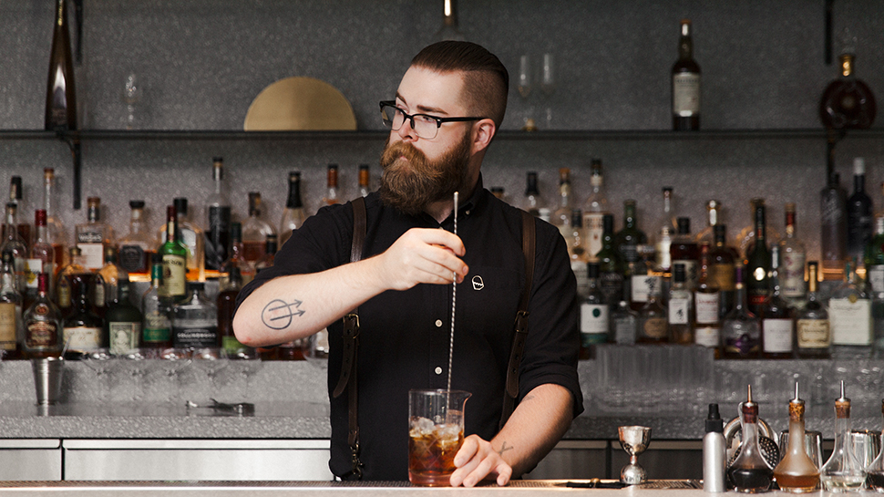 Fairmont Pacific Rim's bartender mixing a cocktail