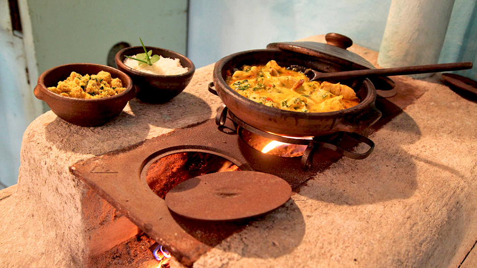 Stew cooking over fire at UXUA Casa Hotel & Spa