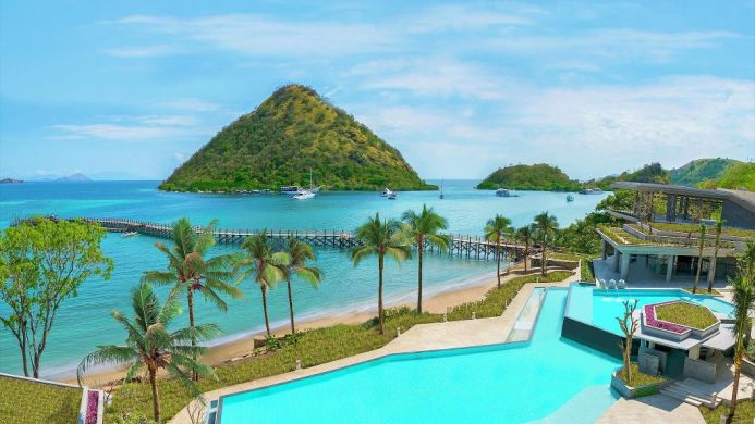 AYANA Komodo Resort pool overlooking ocean and green mountains