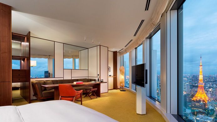 Room with curved windows overlooking evening cityscape and Tokyo Tower