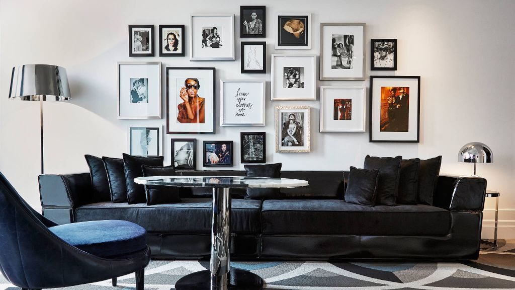 Blue couch with framed gallery wall at Bisha Hotel and Residences