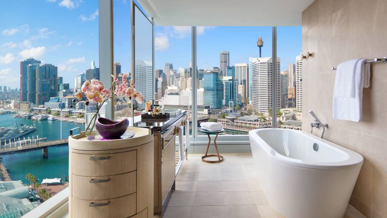 Corner bathroom with floor-to-ceiling views of the city at Sofitel Sydney Darling Harbour