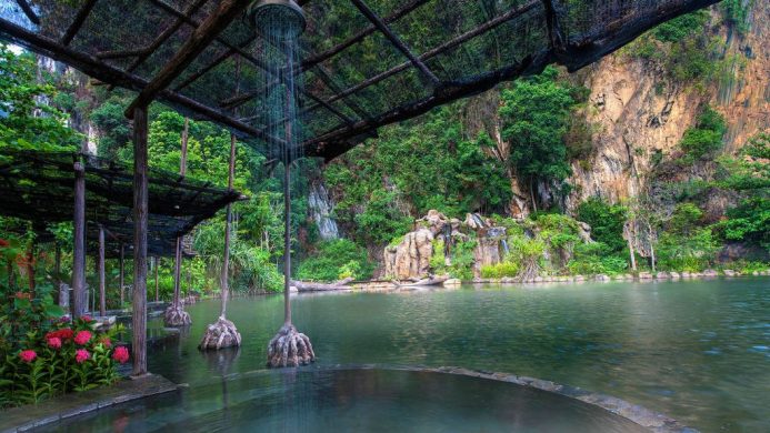 Hot springs pool surrounded by limestone caves