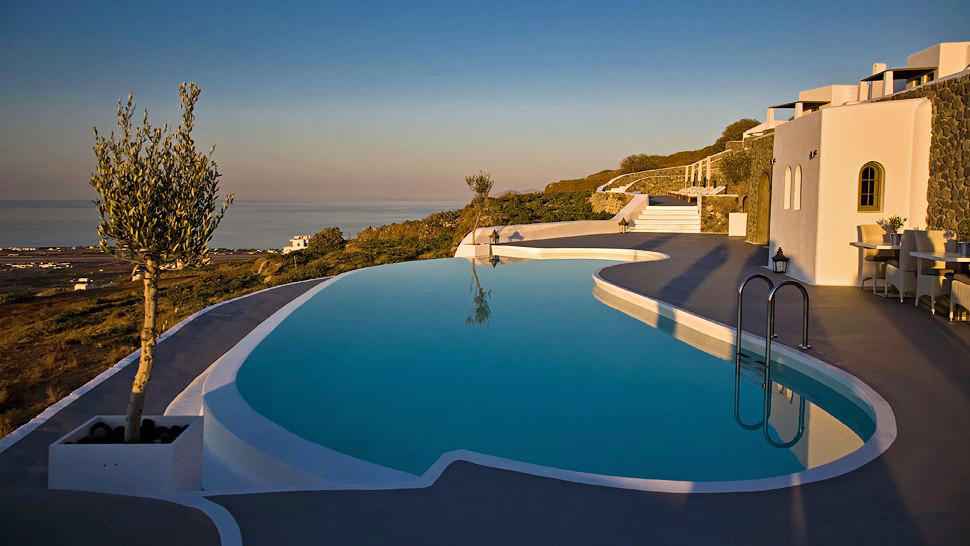 Terrace cliff pool hanging over island landscape and sea at dusk