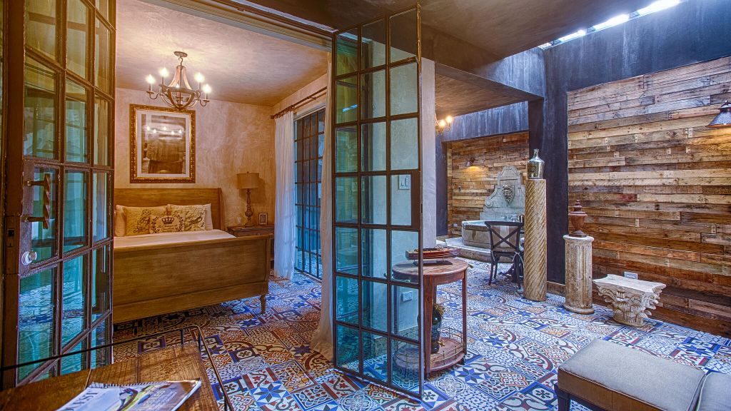 Suite with wooden walls, mosaic tiles, skylight and fountain