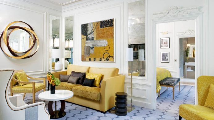 Suite living room with crown moulding and modern yellow sofa