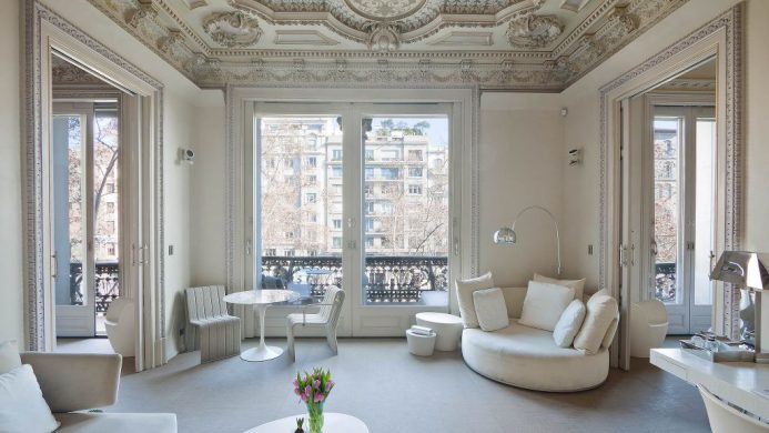 All white apartment with French doors opening to balcony