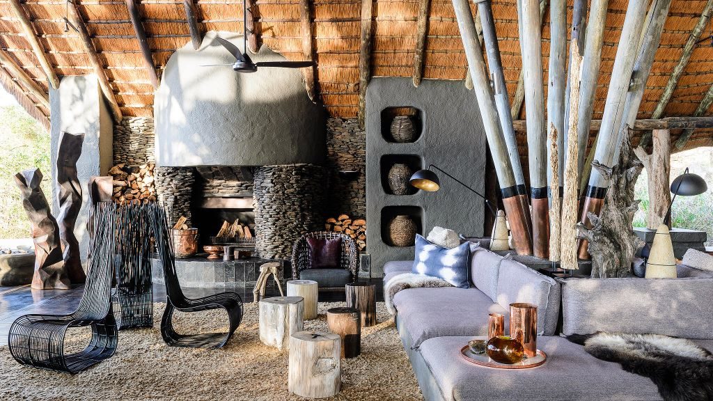 Rustic lounge area with couches and fireplace