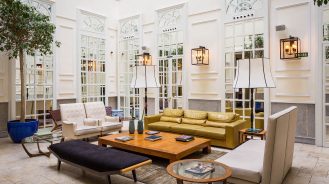 Only You Boutique Hotel - lobby lounge with white mirrored walls, indoor plants and natural light