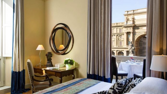 Hotel Savoy's Repubblica Suite bedroom with window view of the piazza