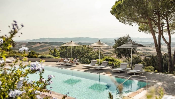 Il Castelfalfi's outdoor pool overlooking rolling hills