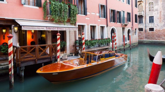 Canal boat arriving to the Splendid Venice hotel's water entrance