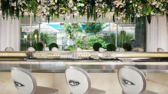 Sanderson hotel's long bar with hanging florals