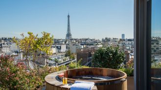 Evok Collection Brach Wood hot tub in the Suite Henri at the Brach hotel, looking out to the Eiffel Tower