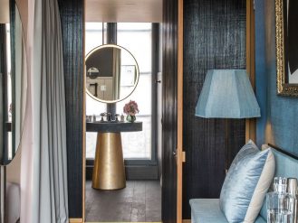 Guest room hallway with cushions and mirrors at Cour des Vosges