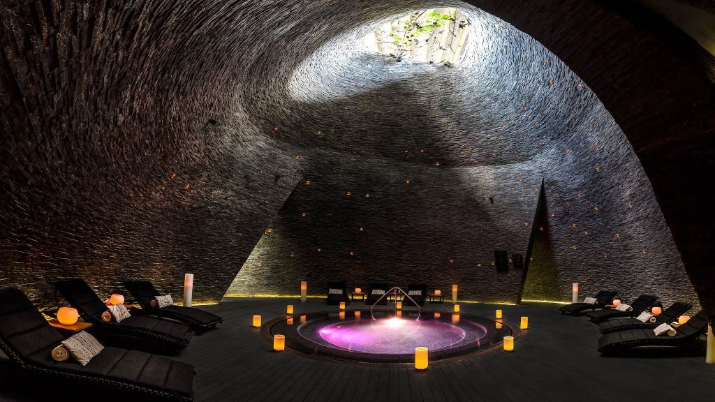 Man-made cenote with spa loungers at the Grand Hyatt Playa del Carmen