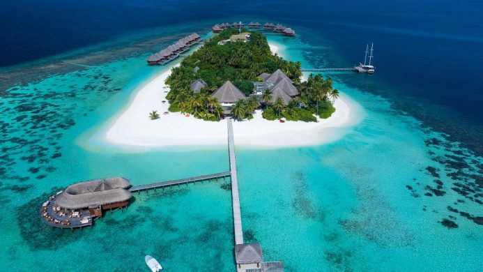 Aerial view of Mirihi Island surrounded by white sand and blue water