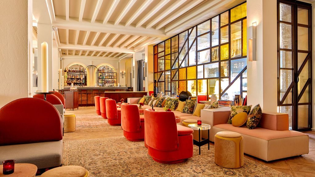 Spacious bar lounge with stained glass windows at the Sinner Paris hotel