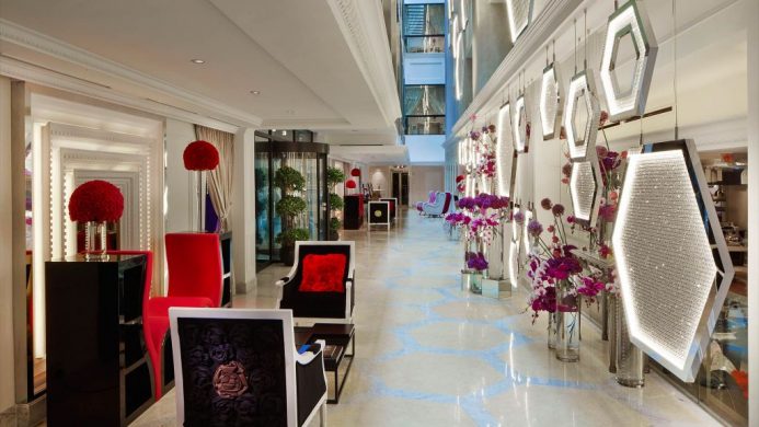 Fashionable chairs and geometric walls with red details at the SO Sofitel Singapore lobby