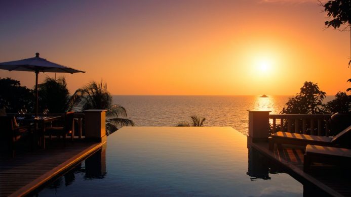 Trisara villa infinity pool looking out to an orange sunset