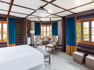 Blue room with wooden log walls at Fairmont Le Chateau Montebello