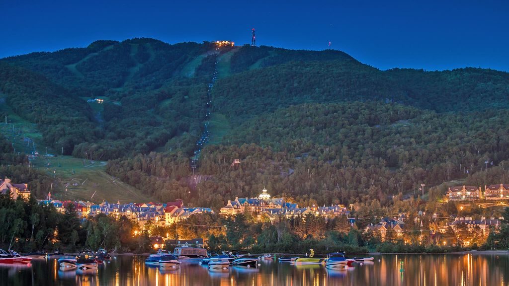 Aerial view of Fairmont Tremblant and ski hill in the background at twilight