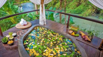Fivelements Bali spa bath hanging over river stream